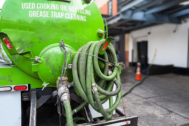 a grease trap pumping truck at a restaurant in Pacheco